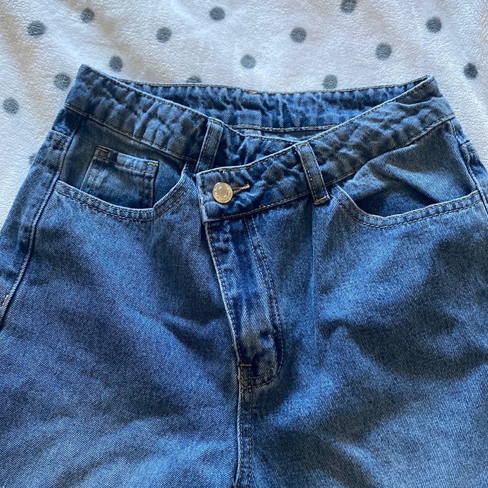 blue washed asymmetric buttoned jeans